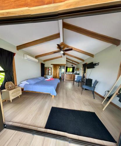 a bedroom with a bed and a ceiling fan at EcoVilla with Pool & HotSprings in Fortuna