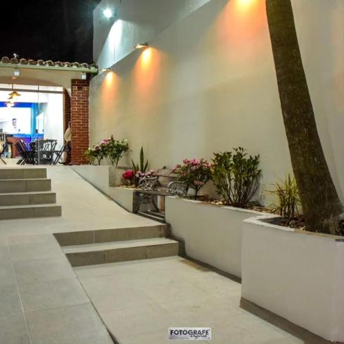 a building with stairs and potted plants at Elegant House with Party Room in Santana do Livramento