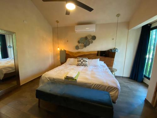 a bedroom with a large bed in a room at Casa Cielo Cancun in Cancún