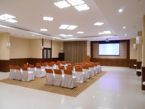 a conference room with chairs and a projection screen at The South Park Hotel in Trivandrum