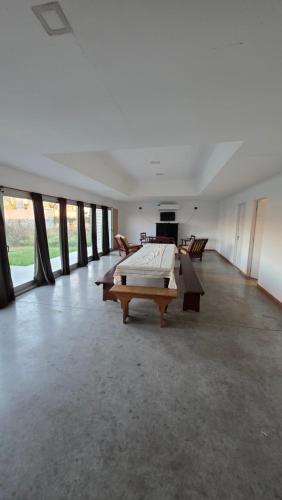 a large room with tables and chairs and windows at Casa Quinta en Villa Nueva Córdoba in Villa Nueva