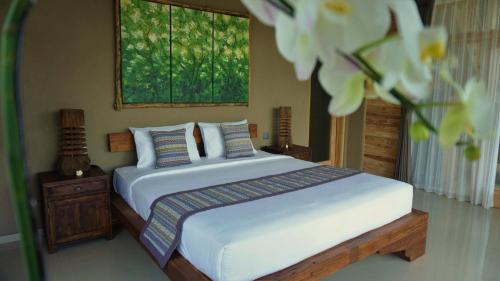 Postel nebo postele na pokoji v ubytování Dukuh Ubud Villa