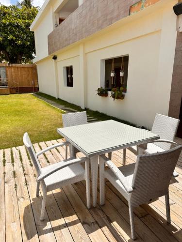 a picnic table and chairs on a wooden deck at Noe hotel in Punta Cana