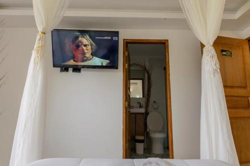 a television on a wall in a bedroom at Hotel Bahia Del Faro in Guatapé