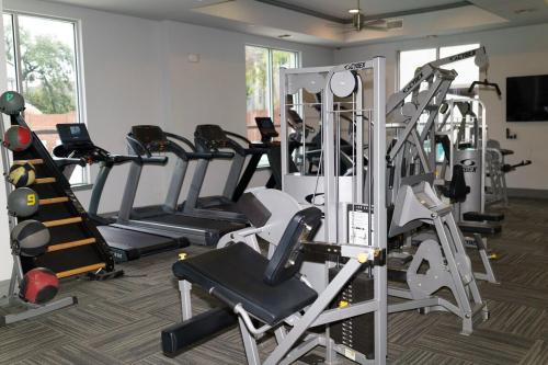a gym with several tread machines in a room at Midtown! Close to Convention Center & Stadiums in Houston