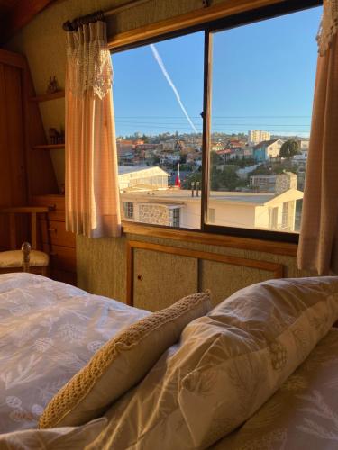 a bedroom with a bed and a large window at CasaOcho2 in Viña del Mar