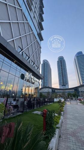 a fire hydrant in front of a building with tall buildings at Elysium Grand Luxury Apartments Fronting Centaurus Mall Islamabad in Islamabad