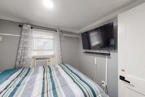 a bedroom with a bed and a flat screen tv at Parrot Bay 35 in Ocean City