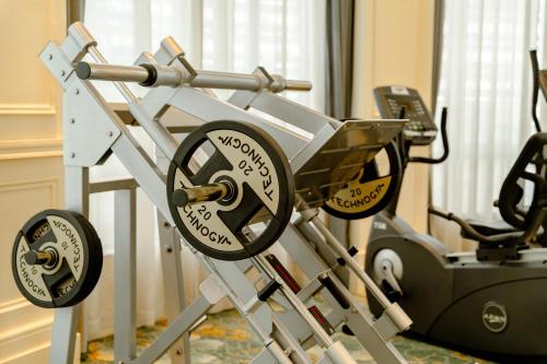 a gym with a treadmill and a machine at The Pury Hotel in Yiwu