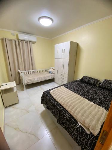 a bedroom with a bed and a crib in it at Panambí Iguazú in Puerto Iguazú