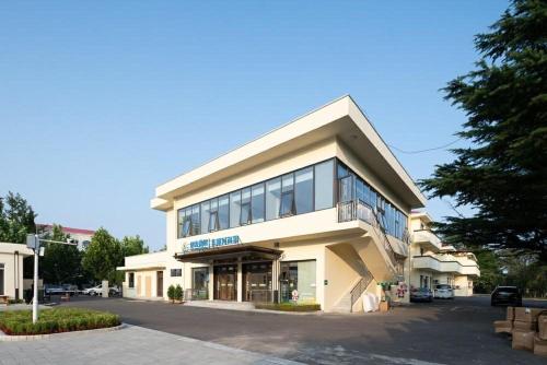 a large white building with a lot of windows at Beidaihe Yijing Hotel in Qinhuangdao