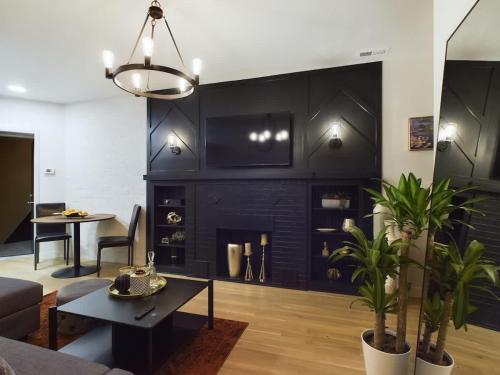 a living room with a black wall with a fireplace at The Velvet Jazz Haus in Chicago