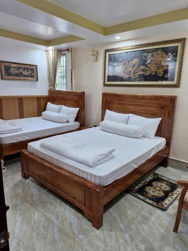 two beds in a room with two at Hostel Luxury Sài Gòn in Rach Gia