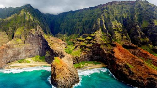 an aerial view of a mountain with blue water at Kauai Explorer Camp Rooftop Camper fully equipped in Anahola