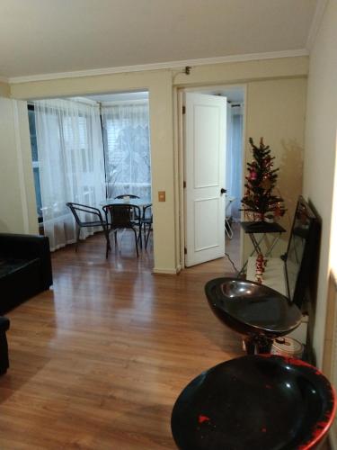 a living room with a christmas tree and a table at Departamento A PASOS CASINO VIÑA in El Cerrillo
