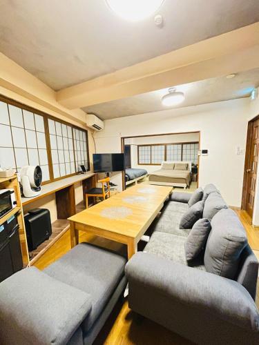 a living room with a couch and a table at Stay Narimasu - 3rooms Apartment, 4min to Narimasu station, 1min to Donki in Tokyo