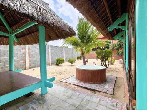 a patio with a hot tub in the middle of a building at Full Moon Village Resort in Mui Ne