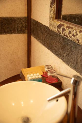 a bathroom with a sink and a mirror and a tub at Full Moon Village Resort in Mui Ne