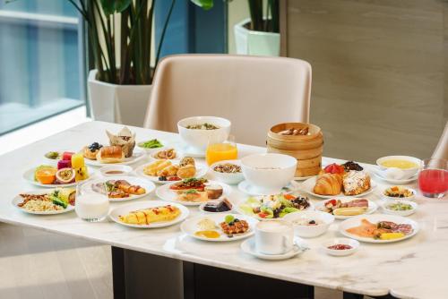 Una mesa con platos de comida para el desayuno. en Hyatt Regency Hangzhou International Airport, en Hangzhou