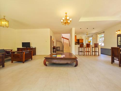 a large living room with a table in the middle at Full Moon Village Resort in Mui Ne