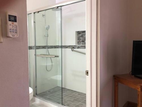 a shower with a glass door in a bathroom at Massive Cherry Garden Home in Cherry Garden