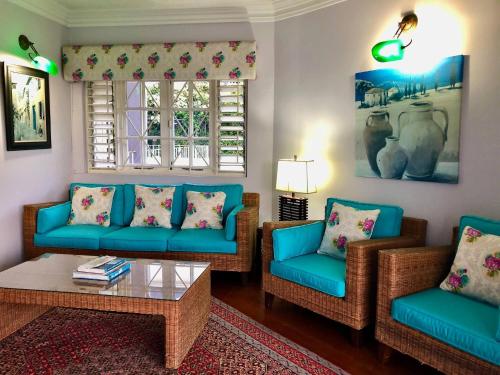 a living room with blue couches and a coffee table at Massive Cherry Garden Home in Cherry Garden