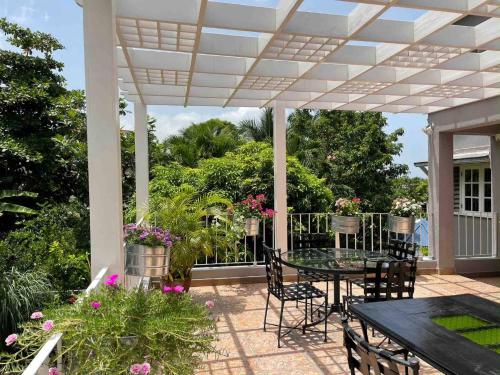 a patio with a table and chairs under a pergola at Massive Cherry Garden Home in Cherry Garden