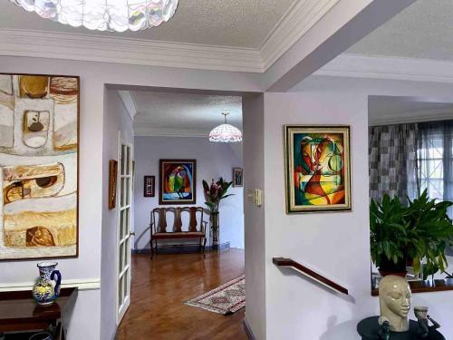 a living room with white walls and a chandelier at Massive Cherry Garden Home in Cherry Garden