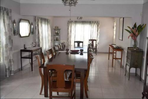 a dining room with a wooden table and chairs at Massive Cherry Garden Home in Cherry Garden