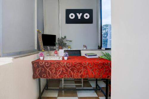 a table in an office with a red table cloth at Hotel O Aqua Comforts in Yelahanka