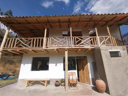 a house with a wooden deck on top of it at Bearded Moutaineer sacred garden & lodge in San Salvador