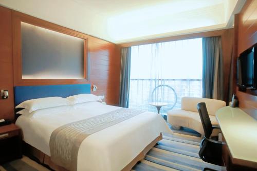 a hotel room with a large bed and a window at Ocean Hotel Guangzhou - Free Shuttle Bus to Canton Fair, Tao Jin railway station in Guangzhou