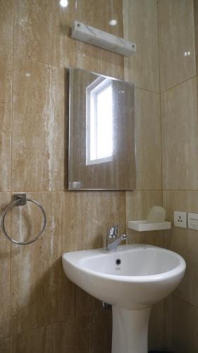 a bathroom with a sink and a mirror at Diyar Villas Puncak K3/2A in Puncak