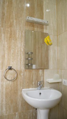 a bathroom with a sink and a mirror at Diyar Villas Puncak K3/2A in Puncak
