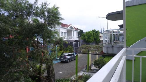 a car parked in a parking lot next to a house at Diyar Villas Puncak K3/2A in Puncak