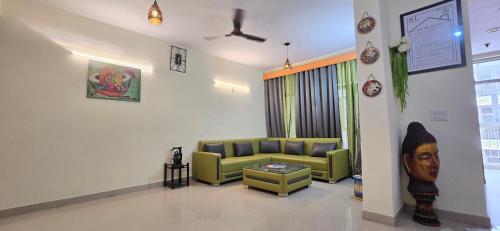 a living room with a couch and a table at BL Homestay & Suite in Agra