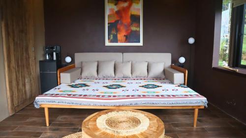 a large bed in a room with a wooden table at Wanagiri Reserve in Gitgit