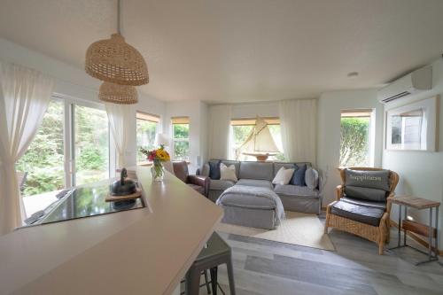 a kitchen and living room with a couch and a table at Beach Bungalow 4 in Cannon Beach
