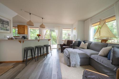 a living room with a couch and a bar at Beach Bungalow 4 in Cannon Beach