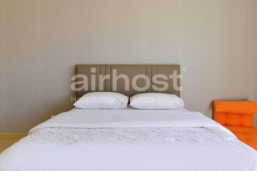 a bed with two pillows on top of it at Encorp Strand Residences by Airhost in Kota Damansara