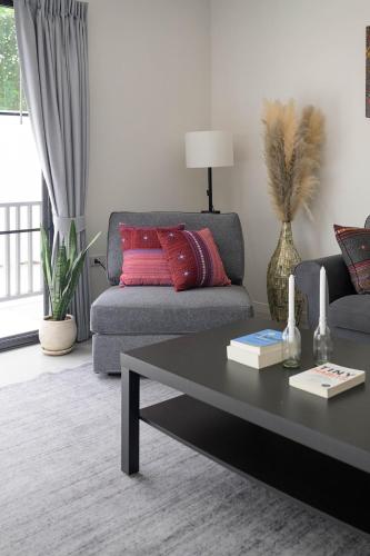a living room with a couch and a coffee table at Coconut Breeze Villa #1 in Haad Chao Phao