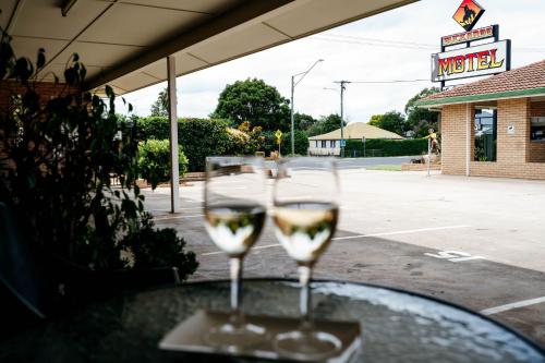 two glasses of wine sitting on a table at Buckaroo Motor Inn in Warwick