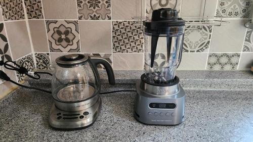 a blender sitting on a counter next to a coffee maker at 하늘이 숨긴 아란야 