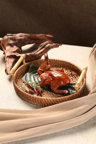 a basket with a figurine of a cat and a cigarette at Sheraton Zhongshan Hotel in Zhongshan