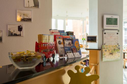 a counter in a store with books on it at Familienhotel Citylight in Berlin