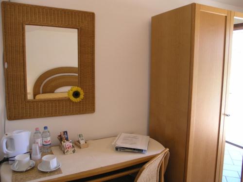 a room with a table with a mirror on it at Agriturismo Podere San Michele in San Vincenzo