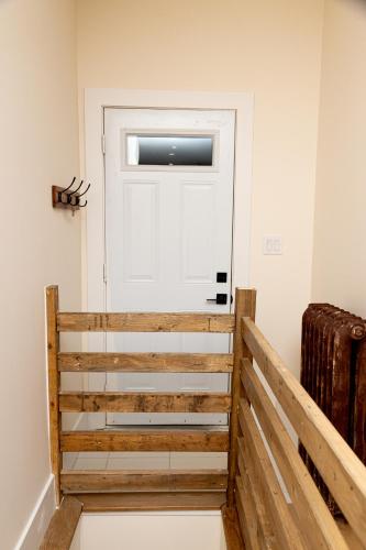 a white door in a room with a wooden staircase at B Hotel in Toronto