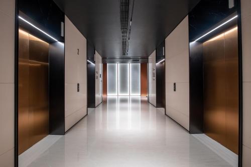a hallway with a row of elevators in a building at Intercity Hotel Shantou CHJ in Shantou