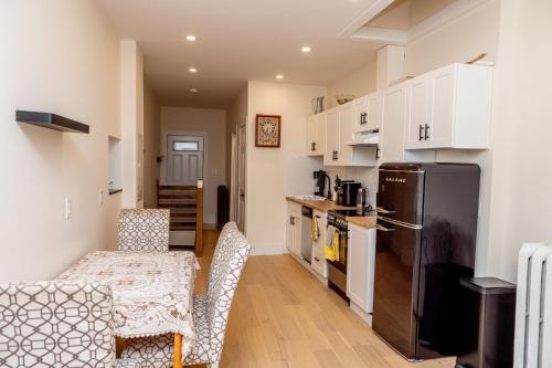 a kitchen with a refrigerator and a table and chairs at B Hotel in Toronto