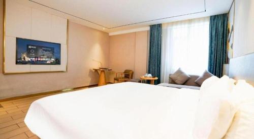 a hotel room with a bed and a couch at Quanzhou Binhai Hotel in Quanzhou